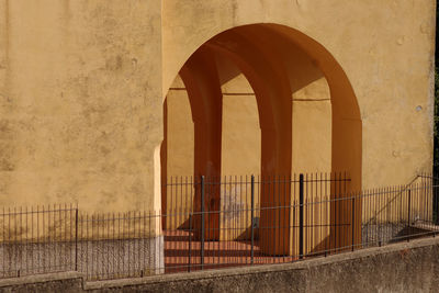 Buildings seen through metal gate