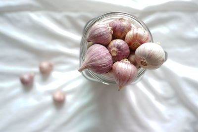 High angle view of grapes in container on bed