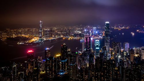 High angle view of illuminated city buildings at night