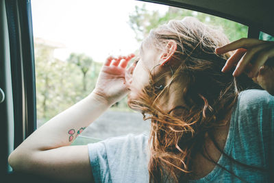 Close-up of young woman sitting in car