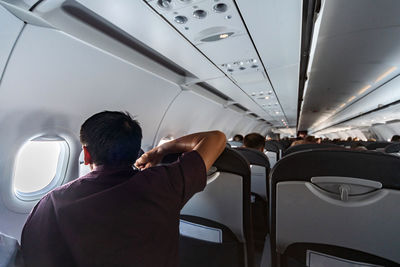 Rear view of people sitting in airplane