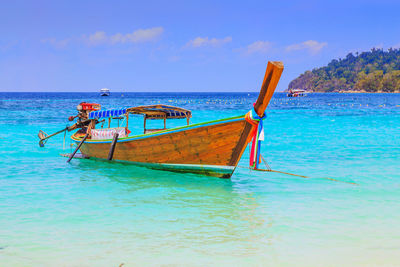 Fishing boat on sea against sky