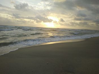 Scenic view of beach against sky during sunset