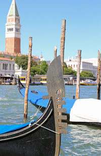 Venice bow of the gondola in the giudecca canal and in the background the bell tower of san marco 