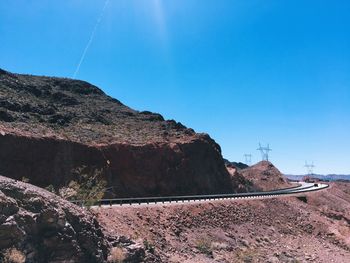 Scenic view of mountains against clear blue sky