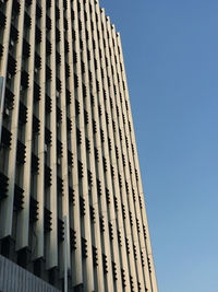 Low angle view of modern building against clear blue sky