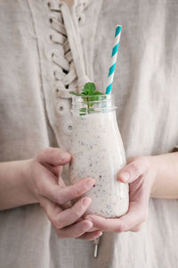 Midsection of woman holding drink