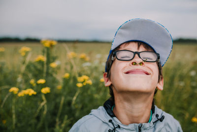 Smiling boy with buds in nose wearing eyeglasses