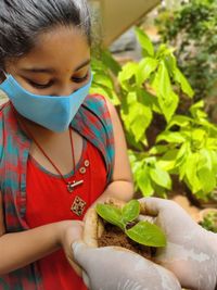 Girl holding plant outdoors