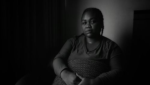 Portrait of young woman sitting at home