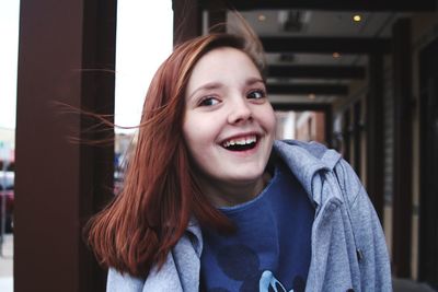 Smiling teenage girl looking away