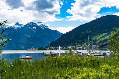 Scenic view of lake by mountains against sky