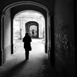 Rear view of woman walking in corridor