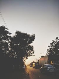 Cars on street against clear sky
