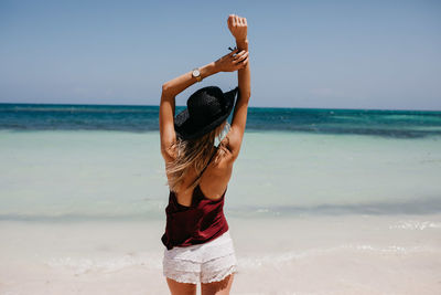 Rear view of man standing on beach