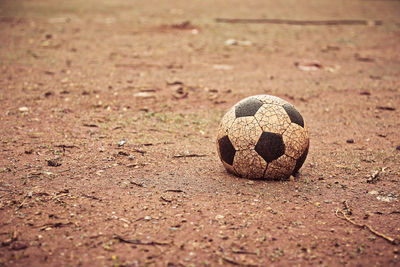 Weathered soccer ball on dirt