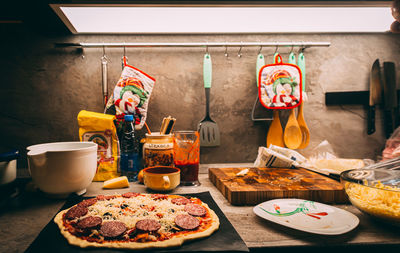 Closeup hand of chef baker in white uniform making pizza at kitchen