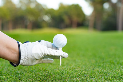 Low section of woman playing golf on field