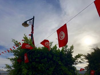 Low angle view of sign board against sky