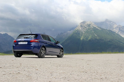 Car on mountain against sky