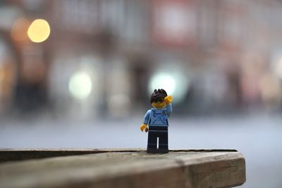Full length of man with toy standing on table