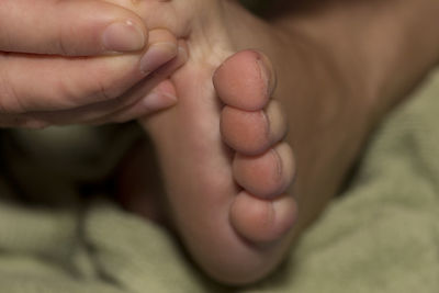 Cropped image of person touching foot