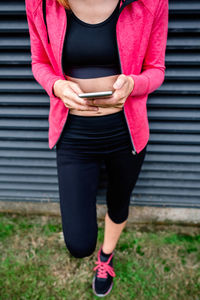 Midsection of woman using mobile phone