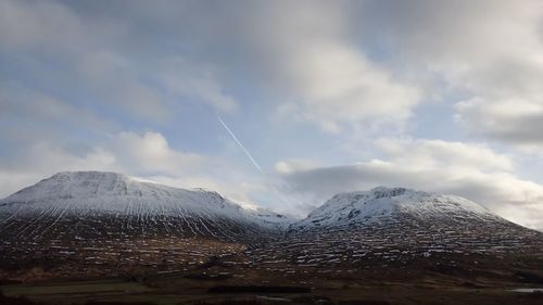 Scenic view of snowcapped mountains against sky