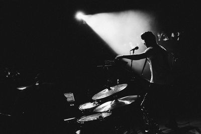 Full length of woman in dark room