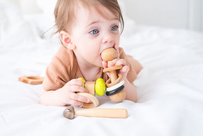 Portrait of cute baby girl holding heart