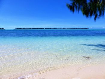 View of beach against blue sky