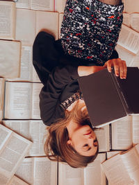 High angle view of woman sitting on book