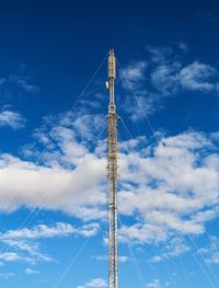 Low angle view of communications tower against sky