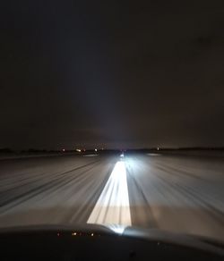 Illuminated road seen through car windshield