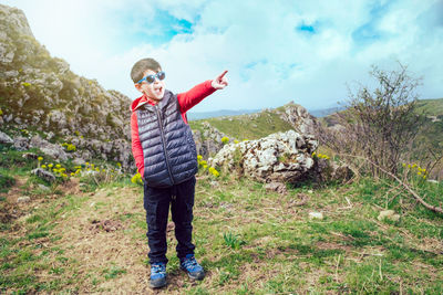 Full length of young man standing on mountain