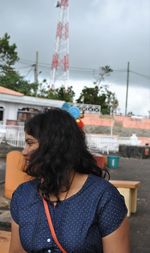 Rear view of woman standing against sky