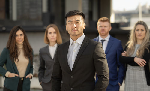 Portrait of business colleagues standing in city