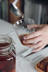 Cropped hand of woman holding drink