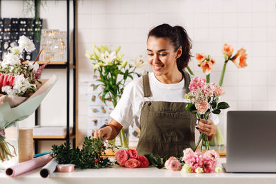 Florist making flower bouquet at shop