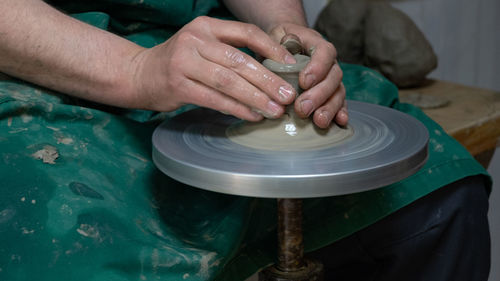 Midsection of man working at workshop