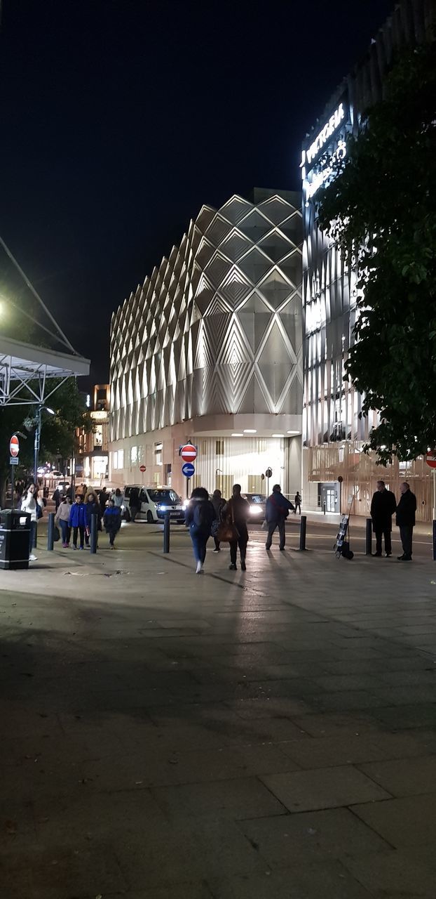 GROUP OF PEOPLE IN FRONT OF BUILDING