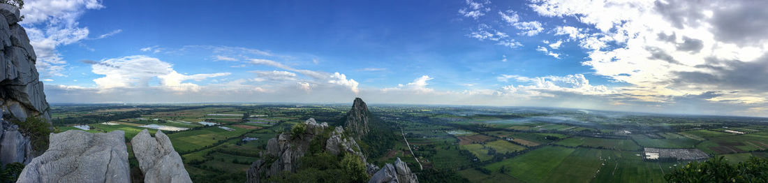 Panoramic view of agricultural field against sky