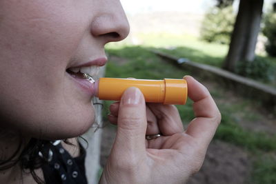 Close-up of woman applying lip balm