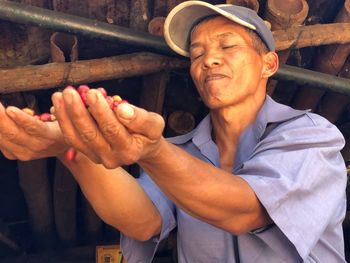 Smiling man holding raw coffee