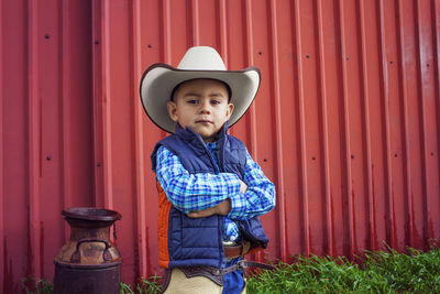 Portrait of confident boy wearing cowboy hat