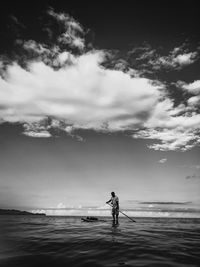 Man standing on beach against sky