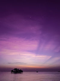 Scenic view of sea against romantic sky at sunrise