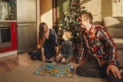 Parents playing with son at home during christmas