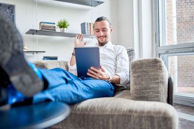 Smiling man talking on video call at home