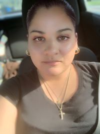 Portrait of young woman in car